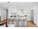 Modern kitchen featuring stainless steel appliances, an island with chairs, and sleek white cabinets at 2425 Peachtree Ne Rd # 903, Atlanta, GA 30305