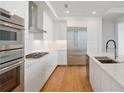 Modern kitchen with stainless steel appliances, white cabinets, and double ovens at 2425 Peachtree Ne Rd # 903, Atlanta, GA 30305