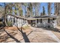 Charming single-story home with brick facade, dark shutters, driveway, and inviting landscaping at 3699 Narron Sw Dr, Atlanta, GA 30331
