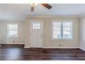 Living room featuring wood-look flooring, two windows and a white front door at 1662 Flintwood Se Dr, Atlanta, GA 30316