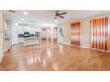 Bright open-concept living room with hardwood floors, modern kitchen, and stylish window treatments at 33 Hardpan Aly, Marietta, GA 30066