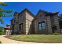 An additional side view shows manicured lawn and detailed stonework at 4520 Mossey Dr, Lithonia, GA 30038