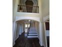Grand foyer with soaring ceilings and elegant staircase at 4520 Mossey Dr, Lithonia, GA 30038