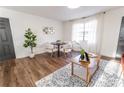 Bright dining area with hardwood floors, modern decor, and comfortable seating at 4776 Ballew Dr, Powder Springs, GA 30127