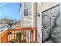 Close up of front door, landing, wood railing, and large window of home at 6138 Raleigh Oaks Ct, Lithonia, GA 30058