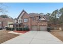 Beautiful two-story home with brick facade and attached two-car garage at 2143 Great Shoals Cir, Lawrenceville, GA 30045