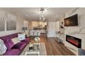 Open-concept living room with a sleek fireplace, kitchen access, and hardwood floors at 2657 Lenox Rd # C30, Atlanta, GA 30324