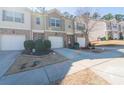 Exterior view of charming townhomes in a well-maintained neighborhood with manicured lawns at 3293 Pennington Dr, Stonecrest, GA 30038