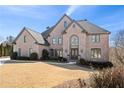 Charming brick home with a well-maintained lawn and mature landscaping at 390 Falls Point Trl, Johns Creek, GA 30022