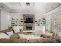 Spacious living room with stone fireplace, white built-ins, wood floors and tray ceiling at 101 Terrace Dr, Atlanta, GA 30305