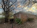Side view of a brick home showing the landscape, including lawn and trees at 2955 Preston Dr, Rex, GA 30273