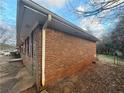 Angled view of the side of a brick house, showcasing its durable construction at 2955 Preston Dr, Rex, GA 30273