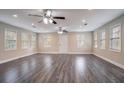Spacious living room with modern gray wood floors, recessed lighting, and multiple windows at 2304 Wesley Chapel Rd, Decatur, GA 30035