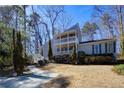 Charming two-story home with a double balcony and well-manicured landscaping at 3550 Beaver Cove Rd, Cumming, GA 30041