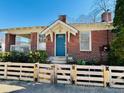 Beautiful brick home with a cozy front yard and light wood fence for added privacy and charm at 38 Bates Se Ave, Atlanta, GA 30317