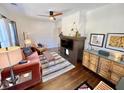 Bright and airy living room featuring a decorative fireplace, modern furniture, and hardwood floors at 38 Bates Se Ave, Atlanta, GA 30317