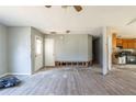 Open-concept living room with gray flooring leading to a kitchen needing renovation at 6381 Phillips Creek Dr, Lithonia, GA 30058