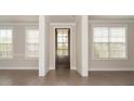 Inviting entryway with wood door, hardwood floors, and natural light at 951 Olmsted Ln, Johns Creek, GA 30097