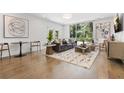 Modern living room with hardwood floors, a large window, and stylish decor at 1002 Citadel Ne Dr, Atlanta, GA 30324