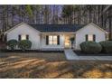 Charming single-story home featuring a well-maintained lawn, classic black shutters, and a welcoming front entrance at 192 Conifer Ln, Rockmart, GA 30153