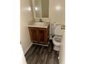 Compact bathroom with vinyl flooring, single sink vanity, and standard toilet at 3636 Hopkins Ct, Powder Springs, GA 30127