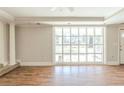 Spacious living room with hardwood floors, crown molding, and a large window at 940 Blair Bridge Rd, Austell, GA 30168