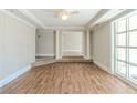 Open living room with hardwood floors, large windows, and decorative columns at 940 Blair Bridge Rd, Austell, GA 30168