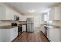 Bright kitchen with white cabinets, granite countertops, and stainless steel appliances at 2236 Chestnut Hill Cir, Decatur, GA 30032