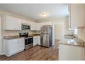Modern kitchen featuring white cabinetry, stainless steel appliances and dark wood flooring at 2236 Chestnut Hill Cir, Decatur, GA 30032