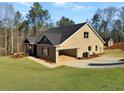 Exterior view of a brick home with attached garage and a well-maintained green lawn at 3402 Milan Ct, Douglasville, GA 30135