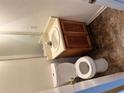 A well lit bathroom featuring a toilet, sink and vanity at 3626 Hopkins Ct, Powder Springs, GA 30127