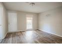 Bedroom featuring neutral tones, a white door, and wood-look flooring at 473 Oakside Sw Dr, Atlanta, GA 30331