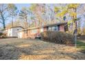 Charming brick home with a well-maintained front yard and attached garage at 473 Oakside Sw Dr, Atlanta, GA 30331