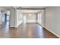 Elegant dining room featuring hardwood floors, chair rail, and modern chandelier at 1064 Wenham Ln, Lawrenceville, GA 30044