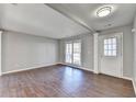 Bright living room featuring hardwood floors and a white entryway door and trim at 1064 Wenham Ln, Lawrenceville, GA 30044