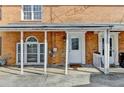 Covered front porch featuring classic brickwork and a decorative front door, creating a welcoming entrance at 933 Carla Pl, Norcross, GA 30093