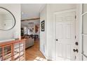 Bright foyer with hardwood floors, view to dining room and exposed wooden beam at 1898 Woodland Hills Nw Ave, Atlanta, GA 30318