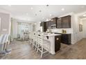 Modern kitchen featuring a large center island with seating, dark wood cabinets, and stainless steel appliances at 2720 Ravencliff Dr, Austell, GA 30168