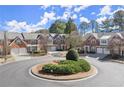 Residential street featuring brick townhomes with well-maintained lawns and landscaping at 913 Thornington Pl, Roswell, GA 30075