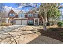 Charming brick townhome featuring a two-car garage and landscaped front yard at 913 Thornington Pl, Roswell, GA 30075