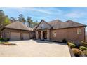 Attractive brick home with multi-car garage, stone columns, and manicured landscape beds at 15 York Trce, Cartersville, GA 30121