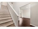 Inviting entryway featuring a staircase and hardwood flooring at 1695 Beckworth Ln, Hampton, GA 30228