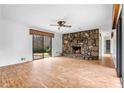 Inviting living room features stone fireplace, wood floors, and sliding glass doors for bright, open living at 2533 Schooner Cv, Snellville, GA 30078