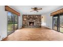 Cozy living room with a stone fireplace and sliding doors allowing for natural light and outdoor access at 2533 Schooner Cv, Snellville, GA 30078