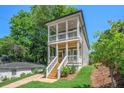 Charming two-story home with a front porch, nestled in a lush, green neighborhood at 57 Moury Se Ave, Atlanta, GA 30315