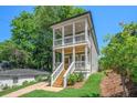 Charming two-story home with double porches, a modern staircase, and a well-manicured lawn at 57 Moury Se Ave, Atlanta, GA 30315