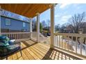 Relaxing outdoor porch with wooden floors, decorative railing, comfortable seating, and neighborhood views at 57 Moury Se Ave, Atlanta, GA 30315