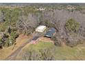 Aerial view of property featuring multiple outbuildings, barn and a large area of land with mature trees at 346 Mays Rd, Stockbridge, GA 30281