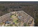 Aerial view shows the house and the property outlined by white line, surrounded by green fields and trees at 346 Mays Rd, Stockbridge, GA 30281