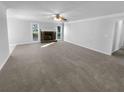 Spacious living room featuring a stone fireplace and neutral walls at 1720 Winners Cir, Lawrenceville, GA 30043